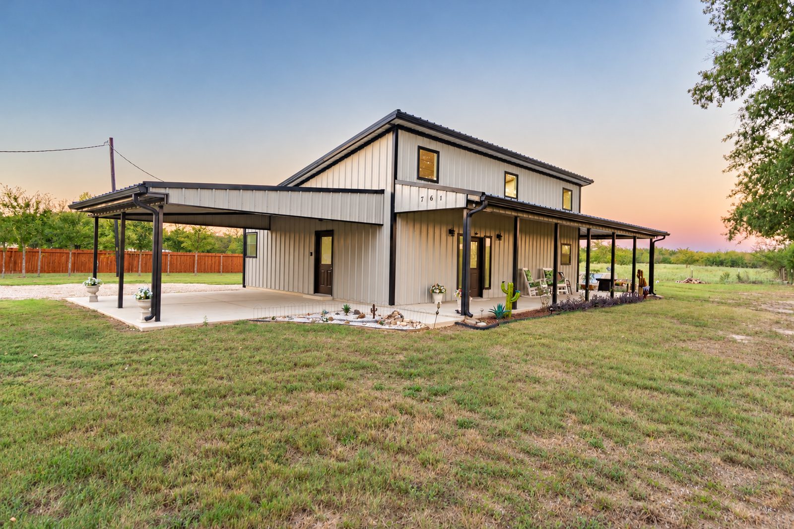 Front of the barndominium at 761 County Road 2910 at sunset