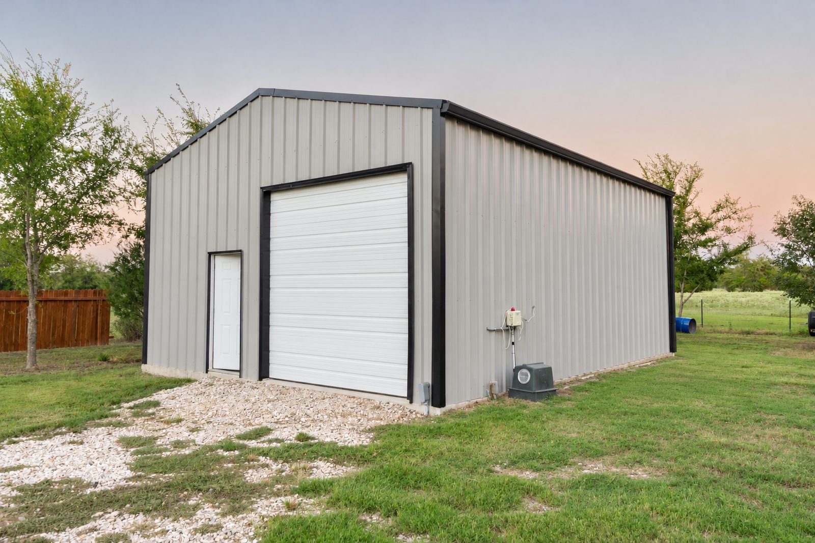 Gray metal shop building with a roll-up door